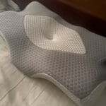 a cervical pillow in bed for working