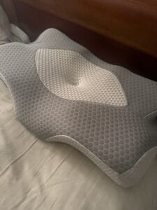 a cervical pillow in bed for working