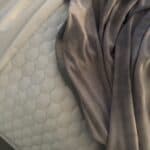 a cooling blanket and cooling topper on bed