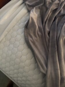 a cooling blanket and cooling topper on bed