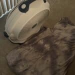 a cooling blanket folded up in front of floor fan