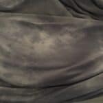 cooling side of blanket laid out on bed