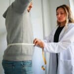 a doctor helping with back pain