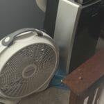 a fan next to portable window AC