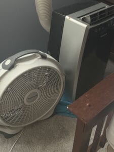 a fan next to portable window AC