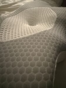 a firm cervical pillow in bed