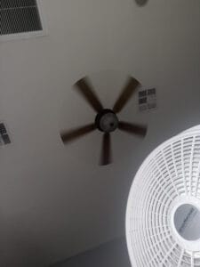 flash photo of both ceiling fan and a floor fan