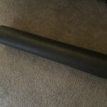 a foam roller for stretching out laid out on floor