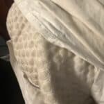 a large cooling pillow on the corner of a bed