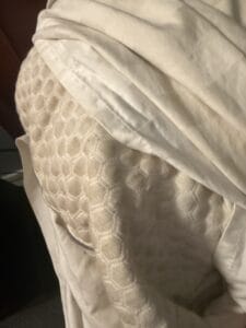 a large cooling pillow on the corner of a bed