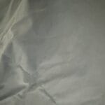 a lightweight comforter upclose on bed