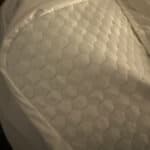 a mattress topper on corner of the bed in home
