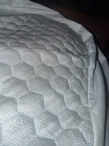 a mattress topper on bed for bedroom setup