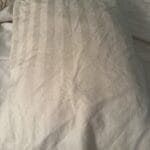 a satin pillowcase on pillow in bed