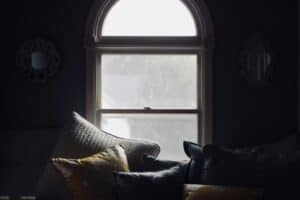 pillows stacked in bedroom by window