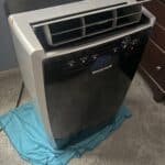 a portable ac with blanket underneath