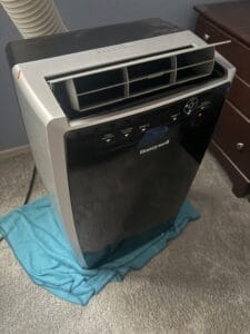 a portable ac with blanket underneath