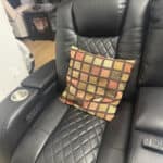 a recliner for napping with throw pillow on it