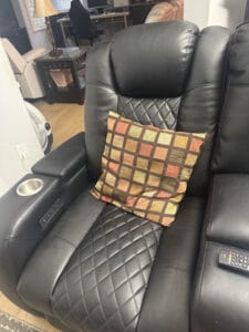 a recliner for napping with throw pillow on it