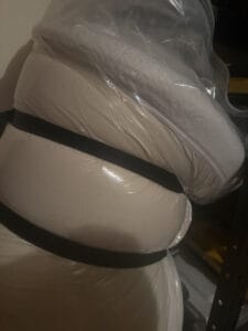 strapped up mattress bag in garage