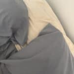 a summer pillow setup on bed