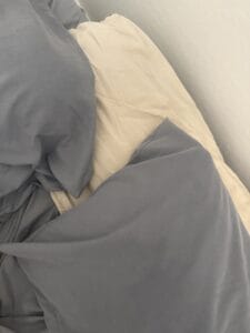 a summer pillow setup on bed
