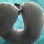 a travel pillow U shape on bed