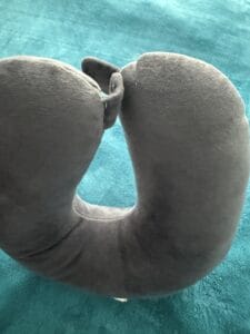 a travel pillow U shape on bed