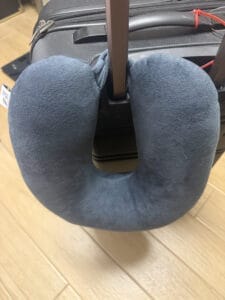 travel pillow latched on to luggage