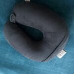 a travel pillow on bed with a U shape for neck