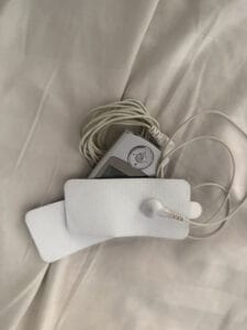 TENS unit laying on bed