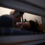 someone on a phone in bed