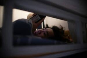 someone on a phone in bed
