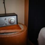 a sound machine on a side table in bedroom