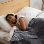 a teenager sleeping in bed