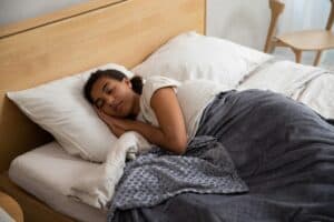 a teenager sleeping in bed