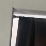 a tension rod on wall for blackout curtains