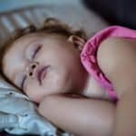 a toddler sleeping in bed