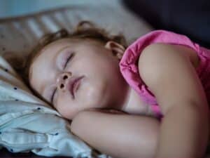 a toddler sleeping in bed