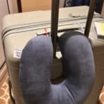 a travel pillow clipped onto luggage