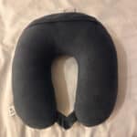 a travel pillow sitting on bed