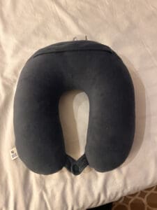 a travel pillow sitting on bed