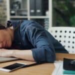 woman fallen asleep at a desk